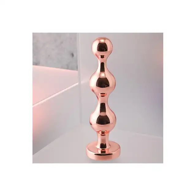 Gender X - Gold Digger M. Średni, elegancki i stylowy. Metalowa wtyczka analna w kolorze rose gold z czarnym klejnotem w podstawie. 