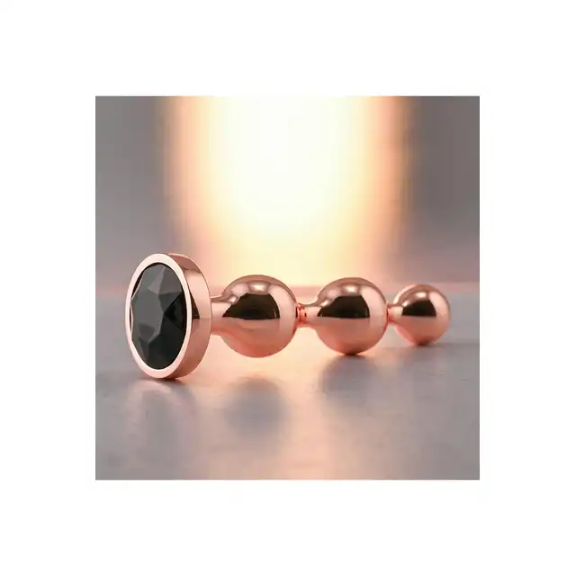 Gender X - Gold Digger S. Mały, elegancki i stylowy. Metalowa wtyczka analna w kolorze rose gold z czarnym klejnotem w podstawie. 