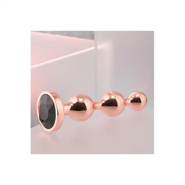 Gender X - Gold Digger S. Mały, elegancki i stylowy. Metalowa wtyczka analna w kolorze rose gold z czarnym klejnotem w podstawie. 