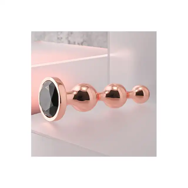 Gender X - Gold Digger L. Duży, elegancki i stylowy. Metalowa wtyczka analna w kolorze rose gold z czarnym klejnotem w podstawie. 