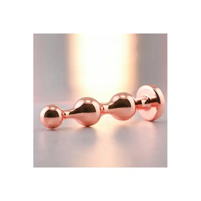 Gender X - Gold Digger M. Średni, elegancki i stylowy. Metalowa wtyczka analna w kolorze rose gold z czarnym klejnotem w podstawie. 