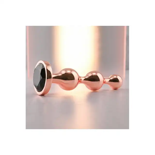 Gender X - Gold Digger L. Duży, elegancki i stylowy. Metalowa wtyczka analna w kolorze rose gold z czarnym klejnotem w podstawie. 