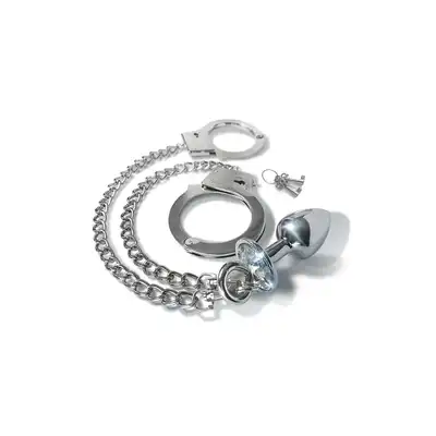 Nixie - Metal Butt Plug &amp; Handcuffs Silver. Zniewalające połączenie korka analnego i łańcuszka prowadzącego do zmysłowych metalowych kajdanek
