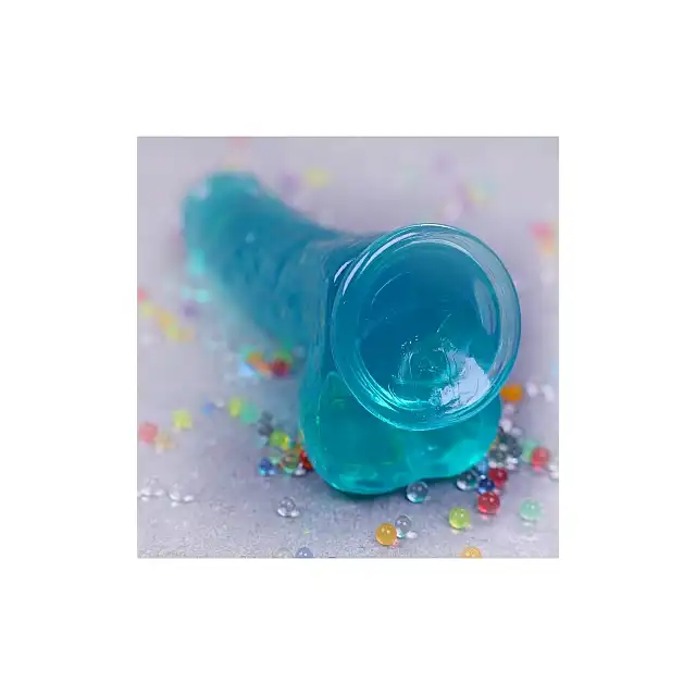 RealRock - Crystal Clear With Balls Turquoise 6". Realistyczne dildo z jądrami, przezroczysty materiał o trukusowym zabarwieniu