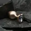 Dream Toys - Gleaming Love Pearl Gold Plug Medium. Złoty elegancki korek analny z kryształkiem w kształcie serca