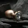 Dream Toys - Gleaming Love Pearl Gold Plug Large. Złoty elegancki korek analny o dużym rozmiarze z kryształkiem w kształcie serca